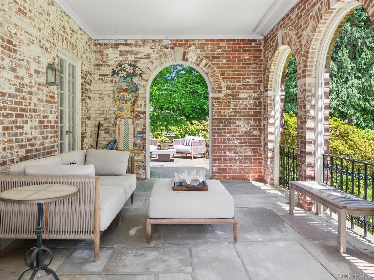 Covered loggia facing park like property