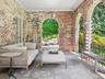 Covered loggia facing park like property