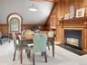 Third floor paneled den with gas fireplace