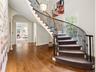 Foyer with sweeping curbed staircase