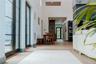 Hallway with a high ceiling and recessed lighting