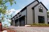 Modern farmhouse style home featuring board and batten siding and a garage