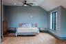 Bedroom with wood finished floors, lofted ceiling, ceiling fan, and recessed lighting