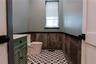 Bathroom with wainscoting, vanity, and wooden walls
