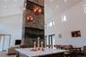 Kitchen with a center island, light stone countertops, a towering ceiling, and recessed lighting