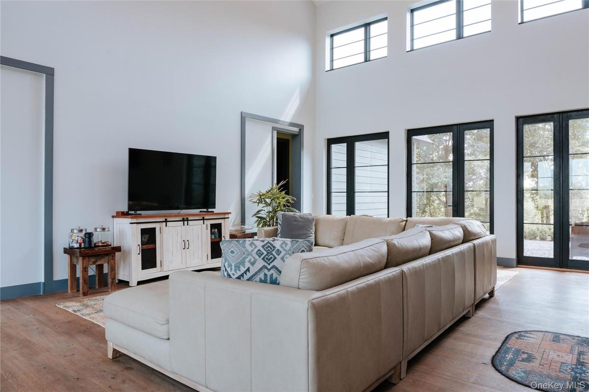 Living room featuring wood finished floors and a high ceiling