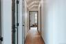 Hall featuring light wood finished floors and lofted ceiling