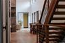Corridor featuring wood-type flooring and a towering ceiling