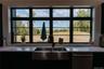 Kitchen featuring light stone counters and dishwasher