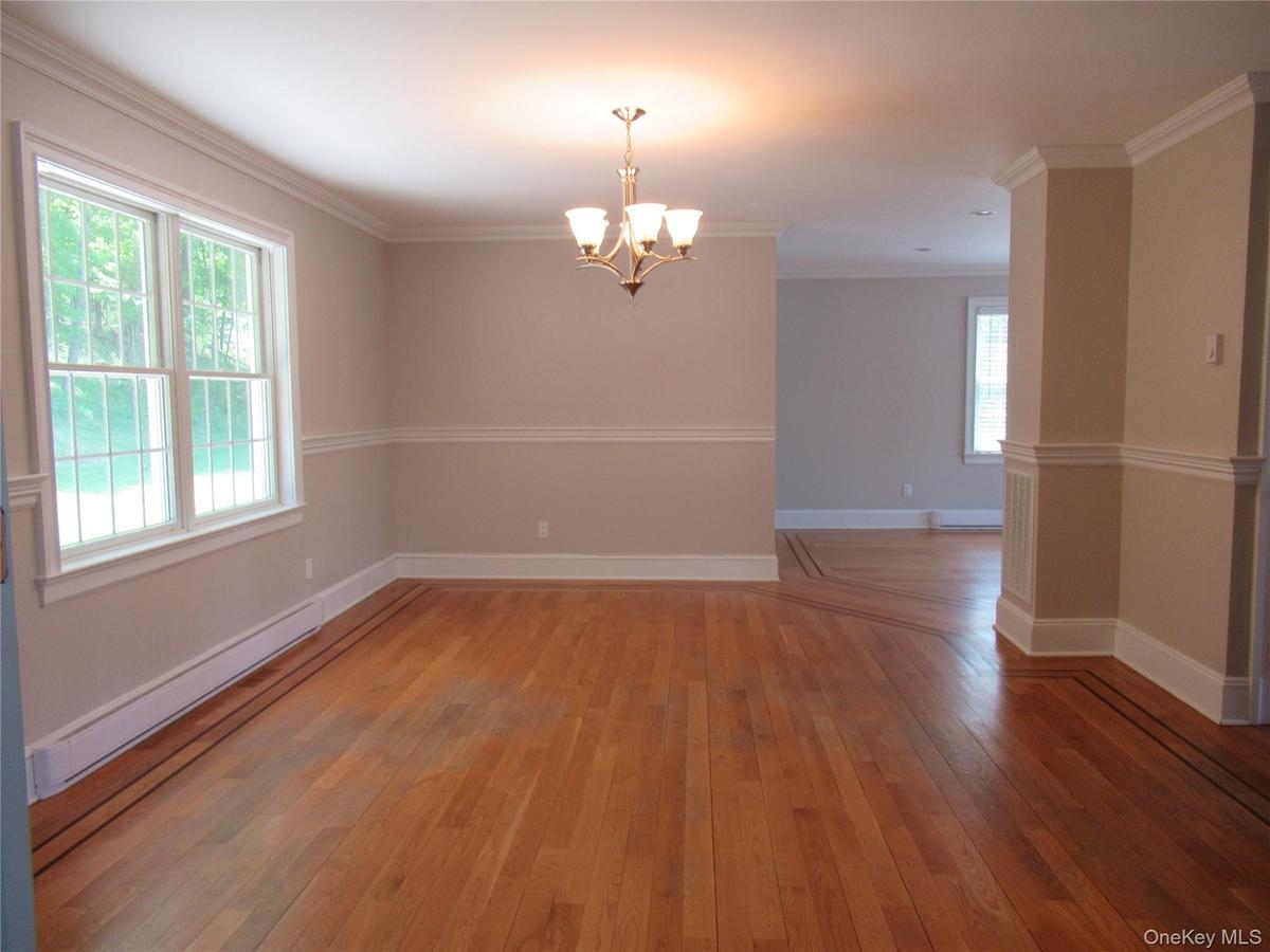 Hardwood floors, Chair rail, Crown molding and Chandelier
