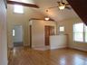 Looking towards the front entrance - ceiling fan, wood beams