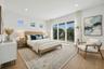 Primary suite with cascading sliders leading to patio deck
