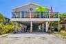 Elevated coastal home with covered parking and spacious upper-level deck, just blocks from the Gulf and steps to Sarasota Bay.