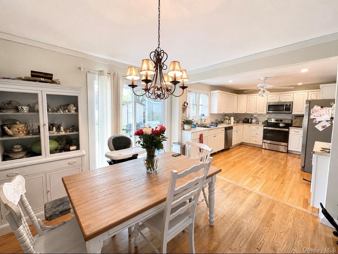 Open-concept kitchen and dining area featuring hardwood flooring