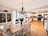 Open-concept kitchen and dining area featuring hardwood flooring