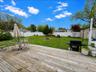 Spacious wood-finish deck overlooking a substantial green lawn