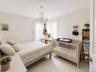 Bedroom featuring white walls and light-toned flooring
