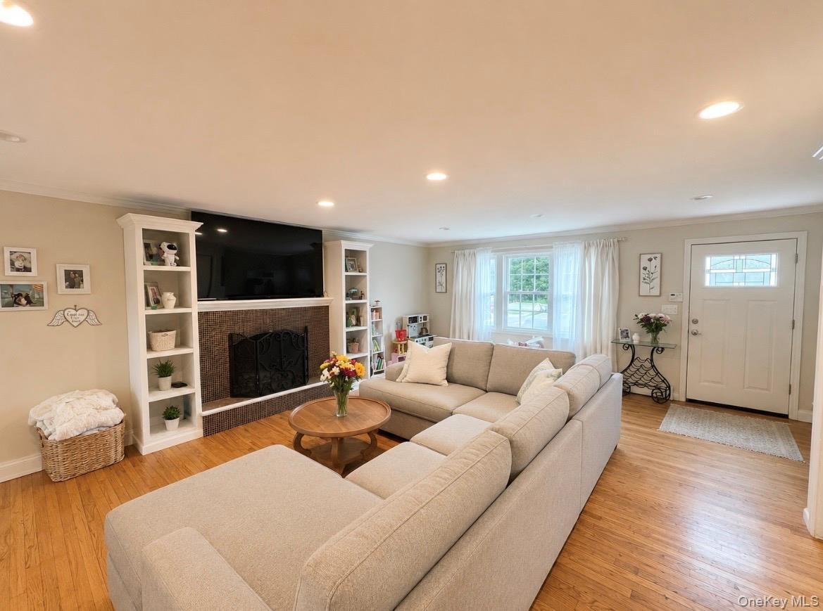 Living room featuring wood-finish flooring and recessed lighting