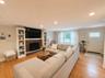 Living room featuring wood-finish flooring and recessed lighting