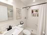 Bathroom featuring a shower with white subway tile surround and a built-in niche