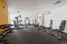 Fitness area featuring a variety of exercise equipment including free weights, weight benches, and cardio machines