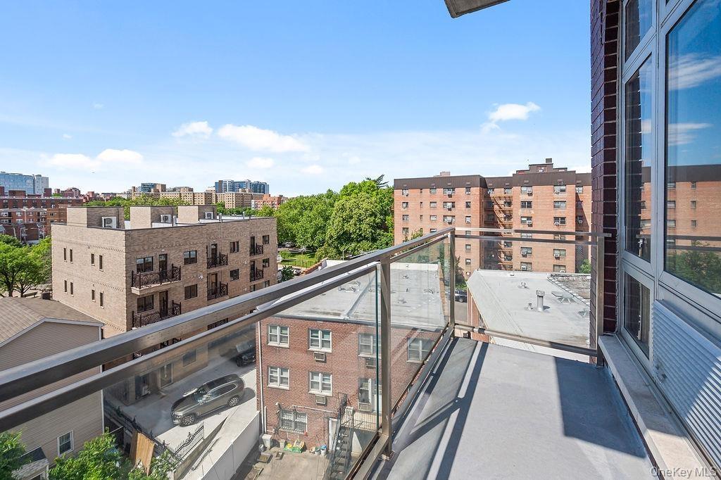 Contemporary balcony featuring a glass railing system and durable surfacing