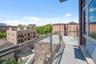 Contemporary balcony featuring a glass railing system and durable surfacing