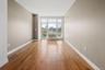 Hardwood flooring extending throughout, complemented by a large window with white framing