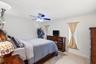 Primary Bedroom is off the Living Room and Includes an En-Suite Bathroom and Big Walk-In Closet Both with Frosted Glass Doors and 18" Travertine Tile 