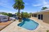 Beautiful Landscape Surrounds Your Waterfront Freeform Pool with Rock Waterfall adds to the Serene Waterfront Lifestyle.