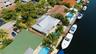 Aerial of the 40' Dock, 70' Seawall, Freeform Pool with Rock Waterfall, Covered Patio Space for Fail Safe Outdoor Patio Perfect for Enteraining. Your 