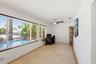 East Facing Florida Room Looks Over the Backyard, Pool, Rock Waterfall, Covered Patio, 40'Dock, 70' Seawall & Ocean Access.