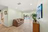 WOW! Your Living Room Views are Awesome! Living Room Extends towards the Backyard, Pool Dock Areas. 18" Travertine Tile Floors, Crown Modling and Impa