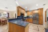 Beautiful Kitchen with Tall Custom Cabinets, Granite Countertops, 2 Snack Bars, SS Appliances & a Built-In Desk included.