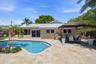 Freeform Pool with Rock Waterfall, Covered Patio Space for Fail Safe Outdoor Enteraining, 40' Dock, 70' Seawall, Aluminum Roof & Travertine Pavers 202
