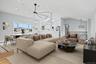 Living room featuring light wood-type flooring, lofted ceiling, ceiling fan, a skylight, and recessed lighting