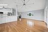 Unfurnished living room featuring a ceiling fan, light wood-style floors, a skylight, recessed lighting, and high vaulted ceiling