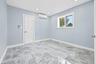 Empty room with light marble finish floors, recessed lighting, and a wall unit AC