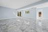 Spare room featuring light marble finish floors, healthy amount of natural light, and recessed lighting