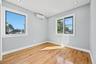 Empty room with light wood-style flooring, recessed lighting, and a wall mounted AC