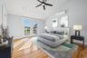 Bedroom with french doors, access to outside, light wood finished floors, a ceiling fan, and an AC wall unit