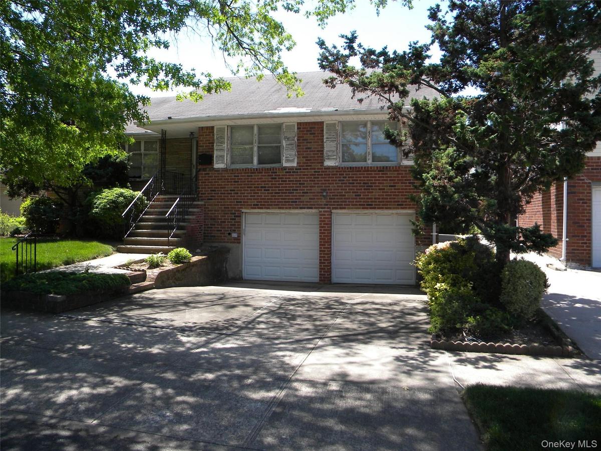 Brick exterior with white shutters. 2 car garage