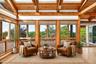 Surrounded by windows and wood, the living room has almost treehouse vibes*virtually staged*
