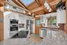 Backdoor guests are best!  Friends and family will enter through the open concept kitchen which features top tier appliances and skylights