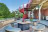 Beautiful stone, tile and granite carved fire pit area by the pool.  Note the spiral staircase from the top deck