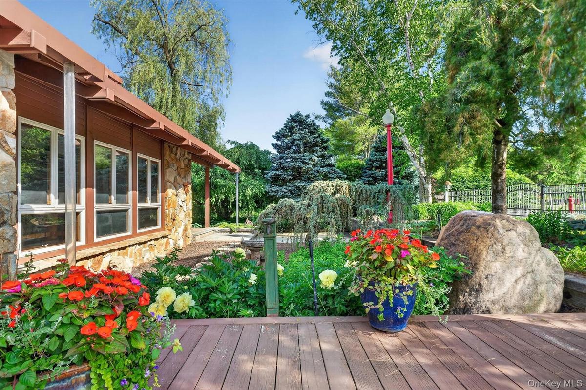 Extensive decks and mature perennial gardens surround the main house