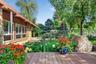Extensive decks and mature perennial gardens surround the main house