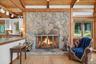Rustic woodburning stone fireplace keeps the home warm and cozy on chilly winter days*virtually staged*