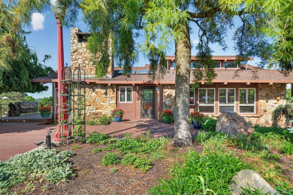 Tucked away behind extensive gardens, the wood and stone home blends seamlessly with the property