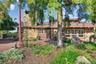 Tucked away behind extensive gardens, the wood and stone home blends seamlessly with the property